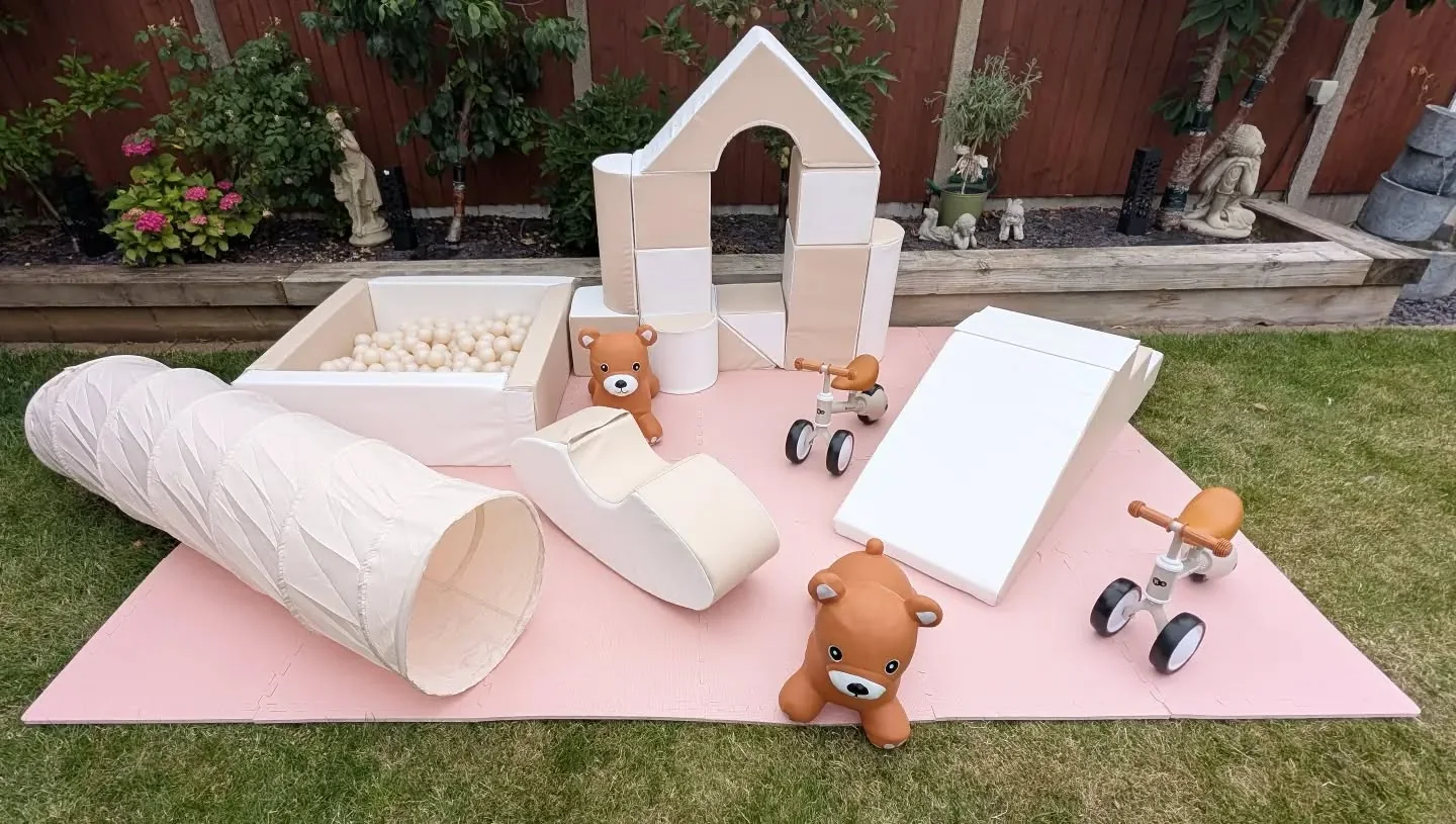 Champagne soft play setup outdoors with ball pit, slide, tunnel, castle blocks and ride-ons
